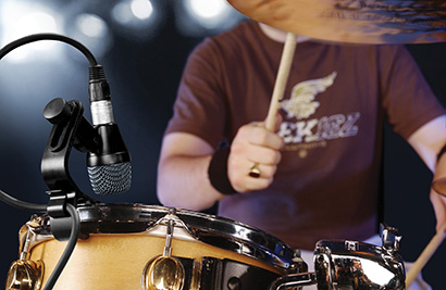 On toms and snares, a cardioid dynamic (such as this Sennheiser e904) — placed slightly above and near the edge of the drum head — offers good tone with little bleed or feedback problems.