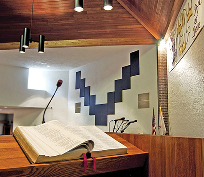 Acoustical absorbers (such as the panels shown here) attached to a highly reflective “hard” wall surface can help break up sound waves that strike it, thus reducing echoes for a cleaner sound with improved vocal intelligibility.