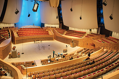 Soundcheck/setup in Bing Concert Hall before the show, showing a few of the 24 QSC HPR122i speakers used for the 22-channel surround system.