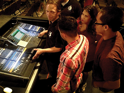 Walter Bush (at the console) explains some fine points of digital mixing on the Yamaha MC7L with volunteers at Destiny Christian Church in Yuma, AZ.