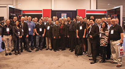 Hosa’s Sho Sato and Mayumi Martinez (in center) and the company’s longest-standing dealers and sales reps strike an historic pose during the 2014 Winter NAMM show.