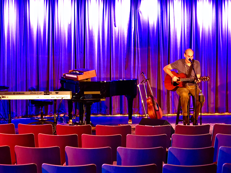 James Taylor runs a quick sound check before the show, using his customary single IEM in left ear and stage wedge on his right side. Photo by David Morgan