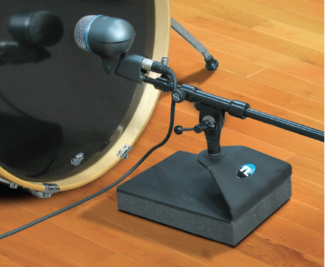 The Primacoustic KickStand (shown here with a Shure Beta 52a microphone) is a heavy mic boom-arm isolator that combines a massive stabilizing base with an isolation pad to eliminate stage or drum riser resonance from entering the microphone.