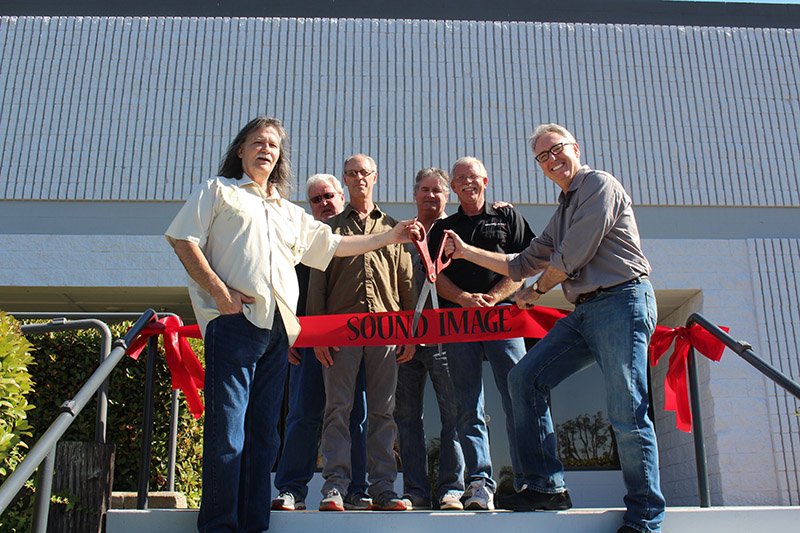 Dave Shadoan (front left) wields the ceremonial scissors for the opening of the company’s expansive new warehouse in Escondido, CA. Also present, from left, are Sound Image’s Ralph Wagner (CFO), Rob Mailman (director of production), Mike Sprague (director of touring), Dave Paviol (director of operations, contracting division and NAMM’S Joe Lamond. Absent are Michael Adams, VP of engineering, and Larry Italia, VP of the contracting division.