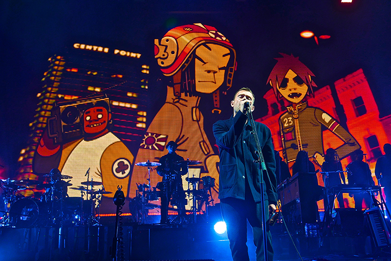 Band co-founder Damon Albarn plays along with animated characters on the big screen.